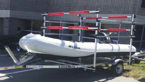 Trailer conversion rack carries boats above a boat on the trailer